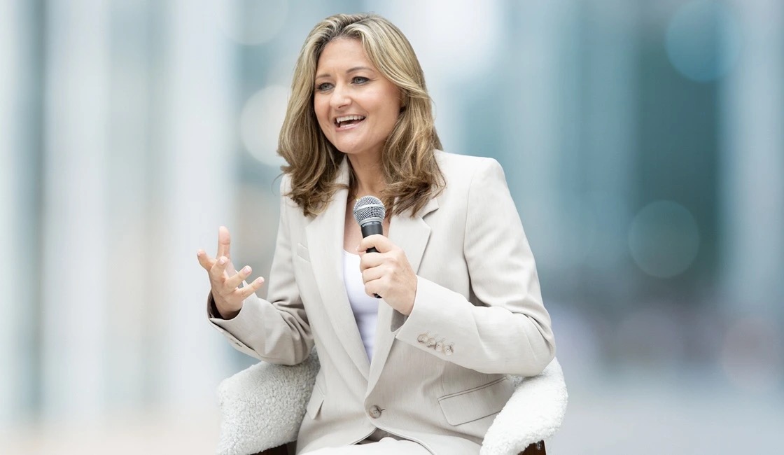 Brandy Gillmore seated on stage with a microphone